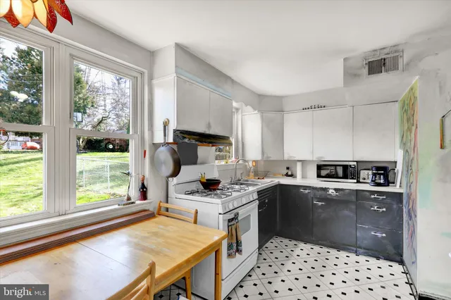 a kitchen with a sink a stove a refrigerator and cabinets