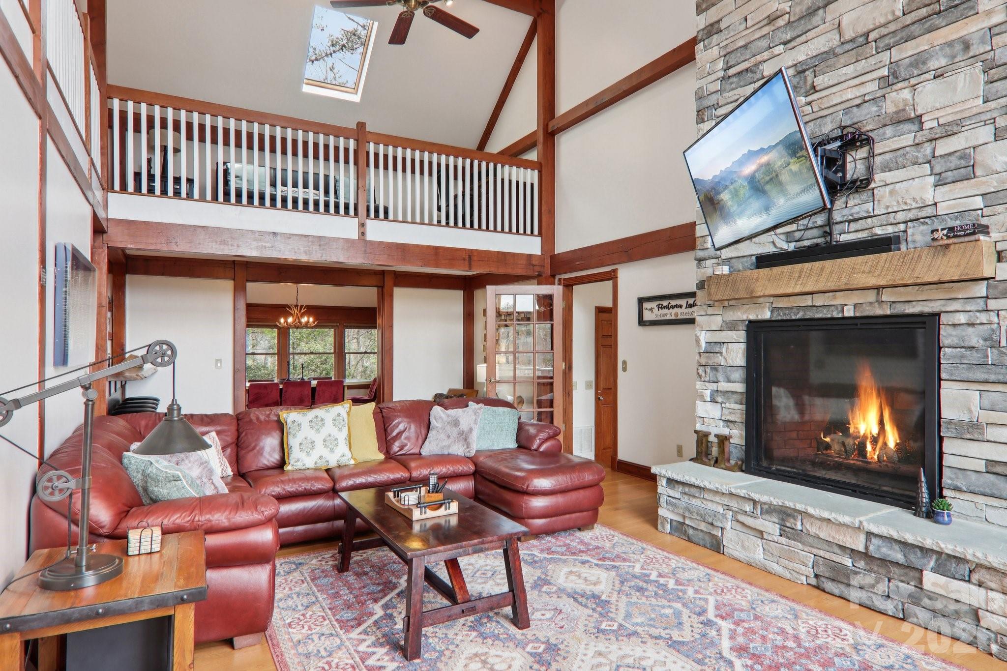 28 Nantahala Ridge Bryson City, NC 28713 - Photo 14 of 47 a living room with furniture a fireplace and a flat screen tv