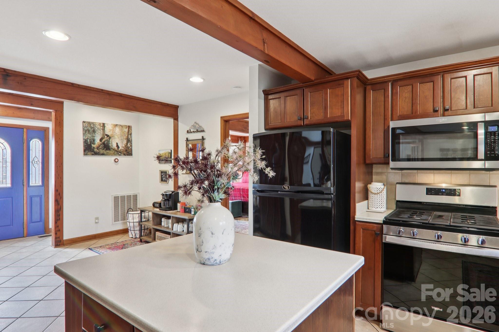 28 Nantahala Ridge Bryson City, NC 28713 - Photo 15 of 47 a kitchen with stainless steel appliances a refrigerator a stove a microwave a dining table and chairs