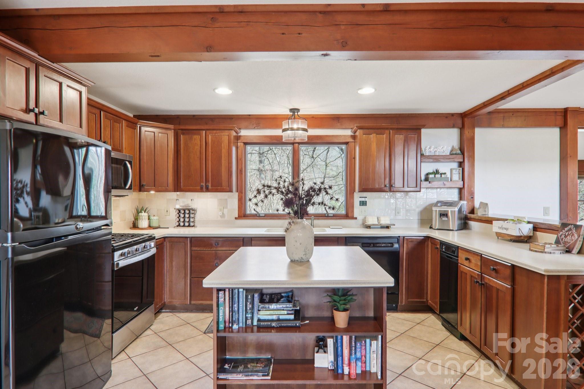 28 Nantahala Ridge Bryson City, NC 28713 - Photo 17 of 47 a kitchen with a stove a sink a dining table and chairs