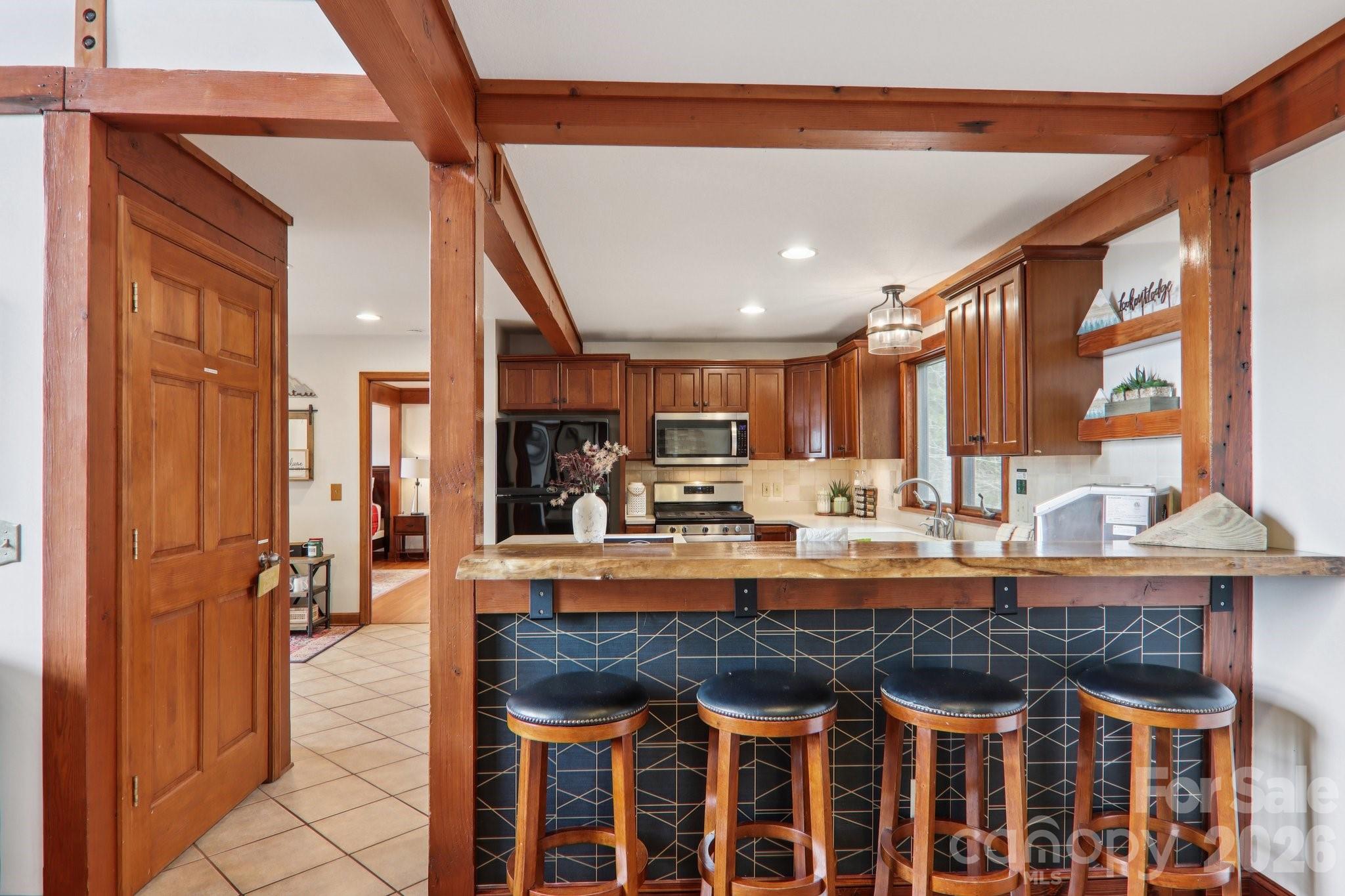 28 Nantahala Ridge Bryson City, NC 28713 - Photo 21 of 47 a kitchen with a table chairs refrigerator and cabinets