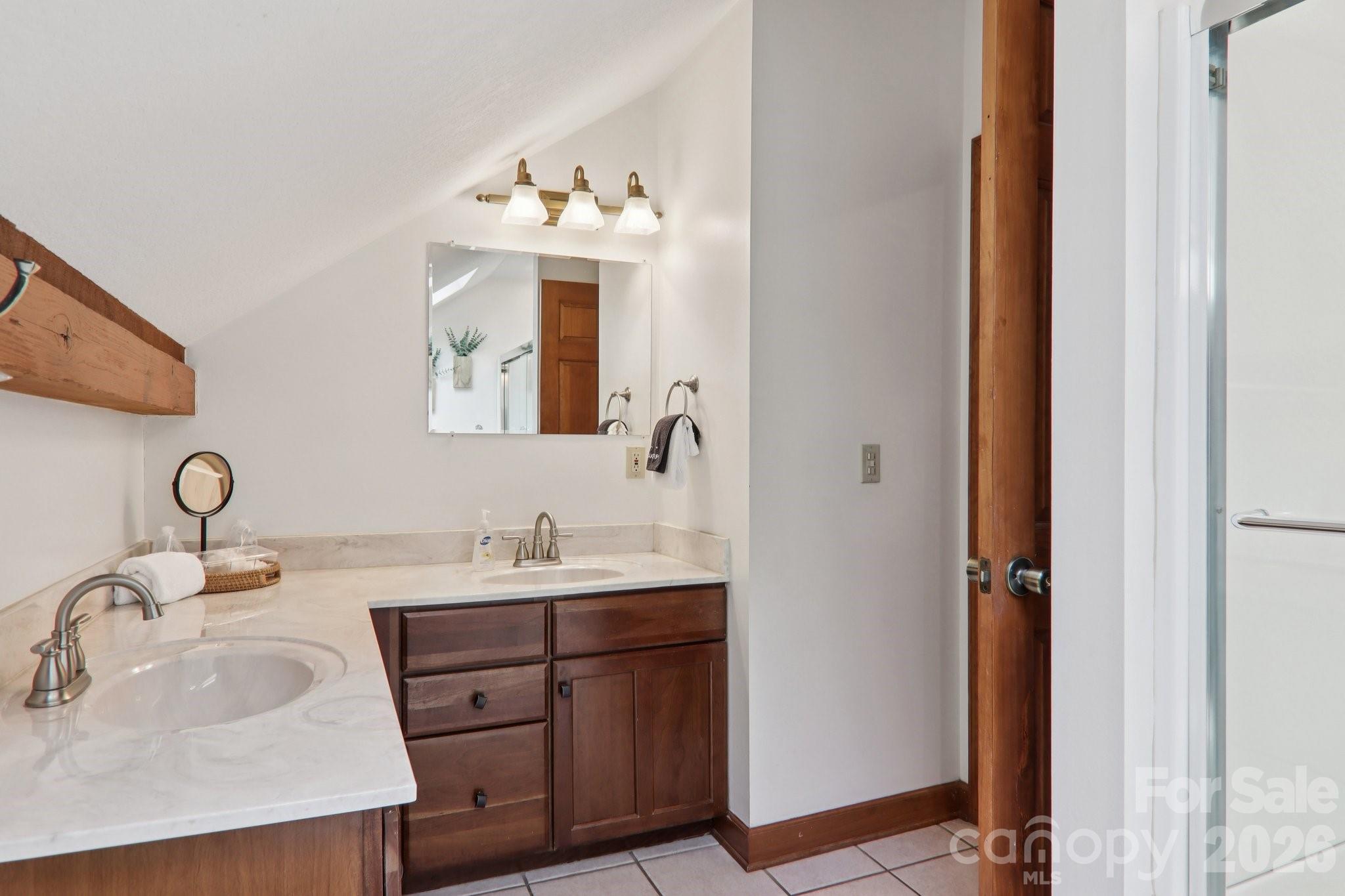 28 Nantahala Ridge Bryson City, NC 28713 - Photo 36 of 47 a bathroom with a sink vanity and a mirror