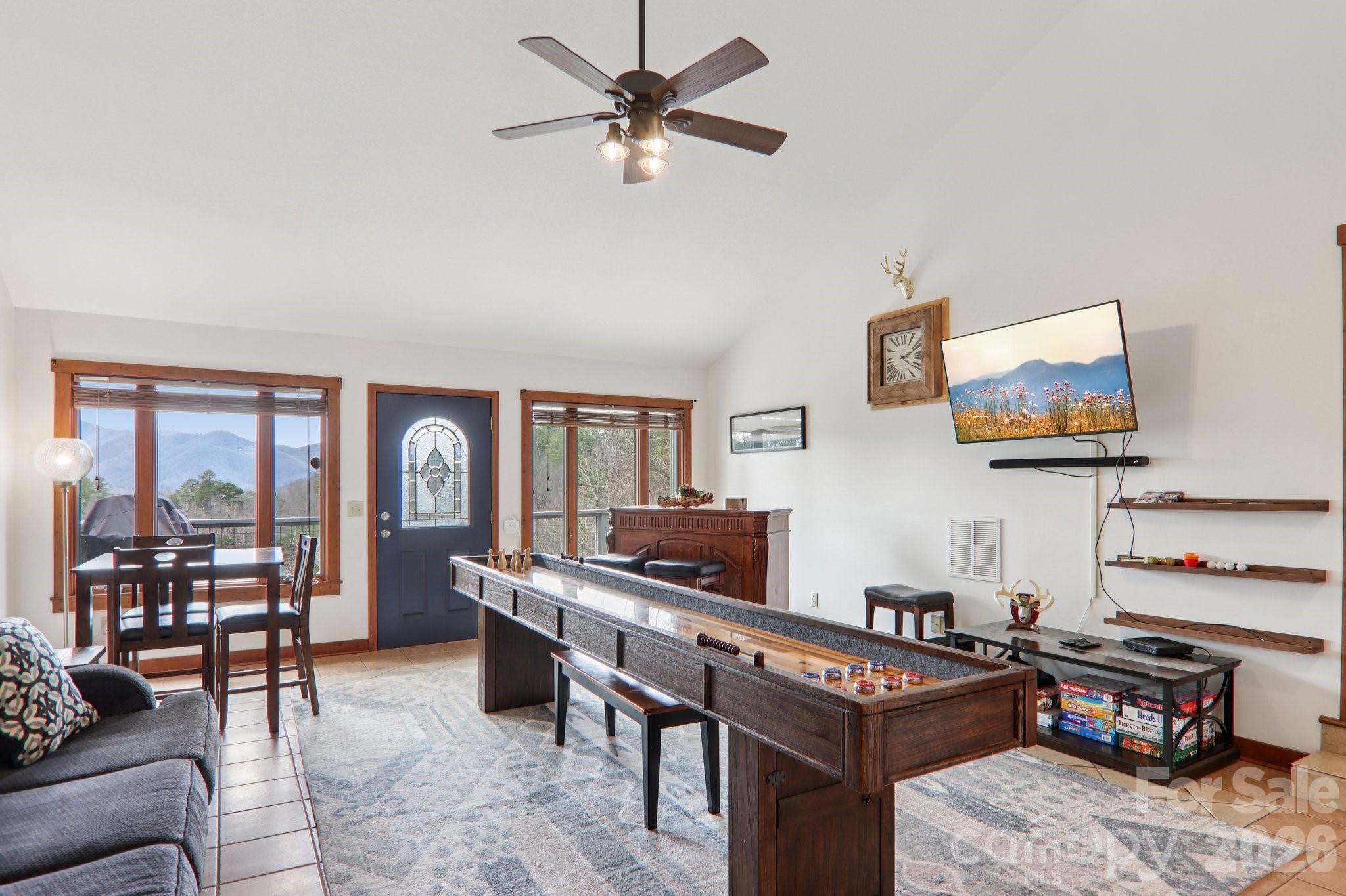 28 Nantahala Ridge Bryson City, NC 28713 - Photo 5 of 47 a living room with furniture a piano and a flat screen tv