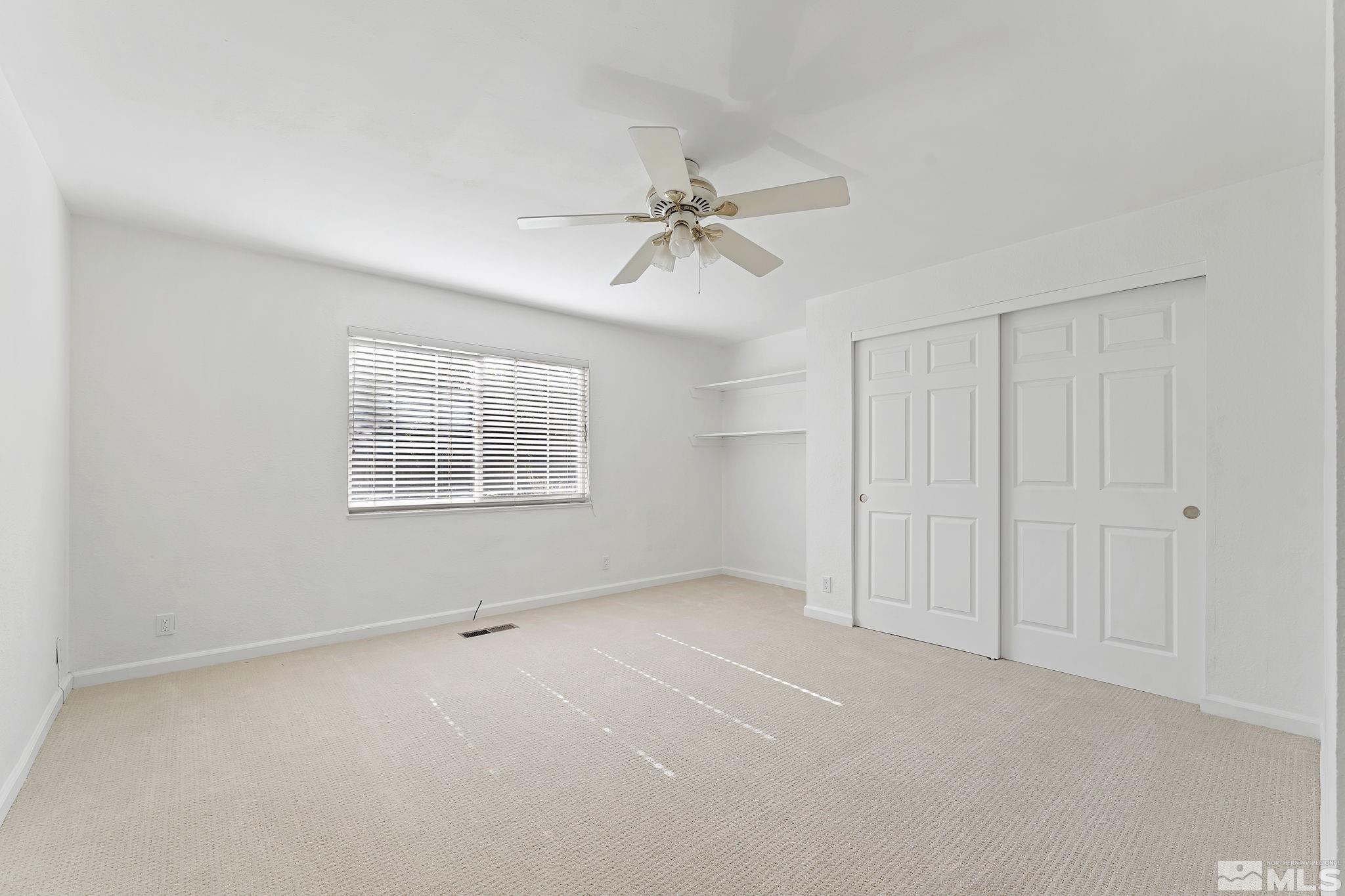 1990 Fallen Leaf Court Reno, NV 89509 - Photo 25 of 32 an empty room with windows and fan