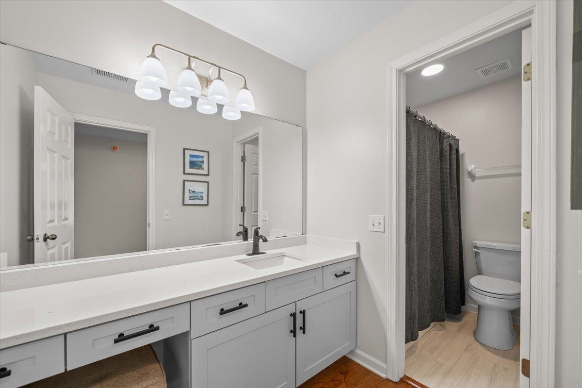 1876 Liles Lane Collierville, TN 38017 - Photo 21 of 36 Bathroom vanity featuring a light gray cabinet with a white countertop, an undermount sink, and a black faucet