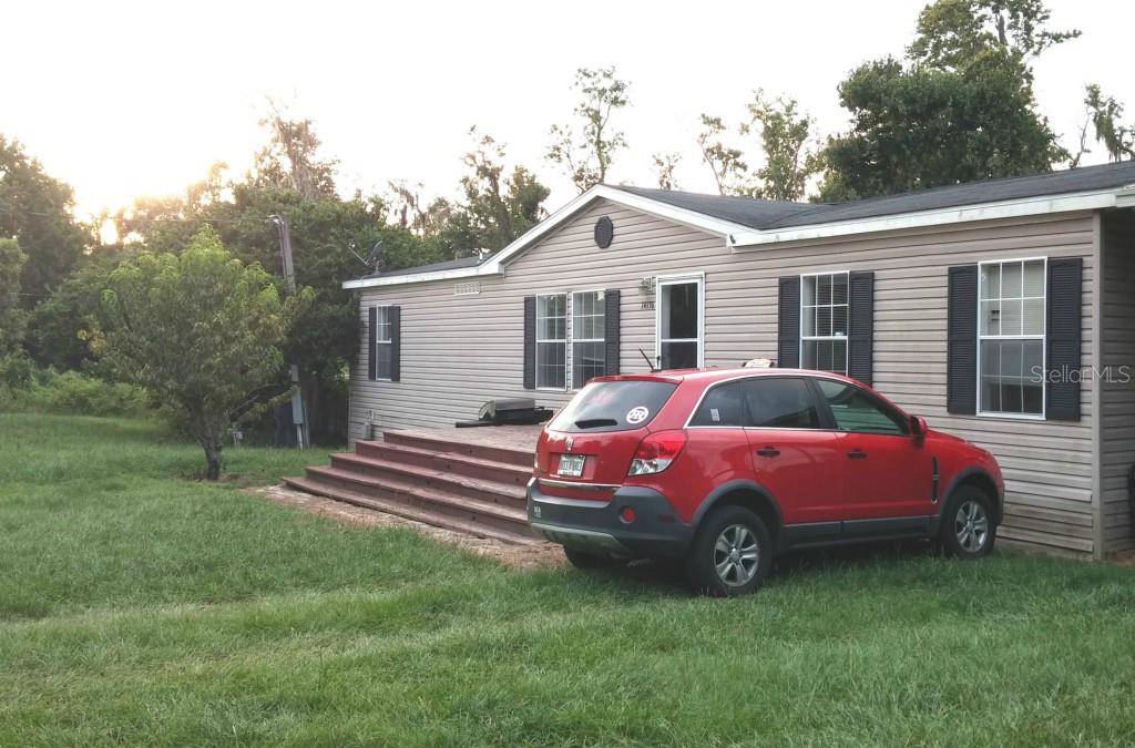 14136 Haynes Road Dover, FL 33527 - Photo 1 of 1 a front view of a house with a garden