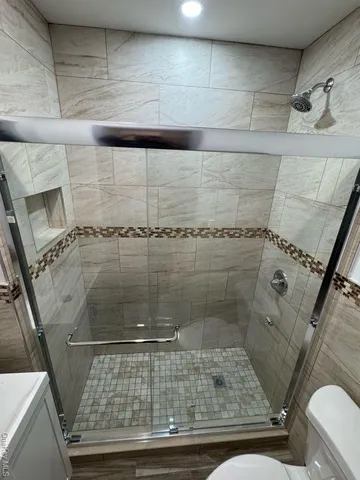 a bathroom with a toilet and a shower