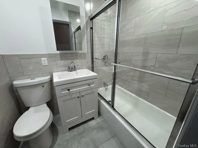 a bathroom with a shower and a sink