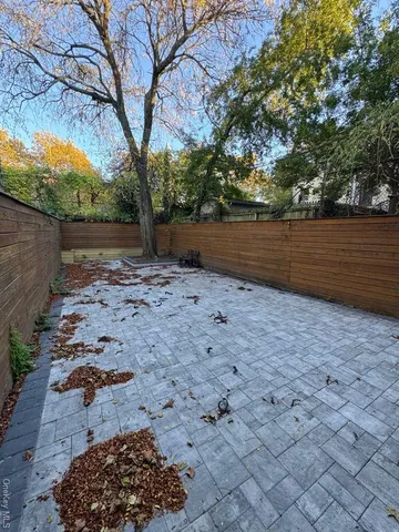 a view of a patio with a table and chairs under an umbrella