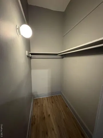 a view of a room with wooden floor and fan