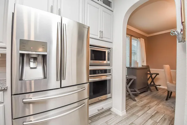 a kitchen with stainless steel appliances a refrigerator stove and microwave