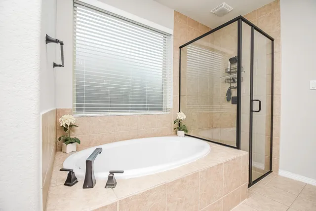 a bathroom with a tub and shower
