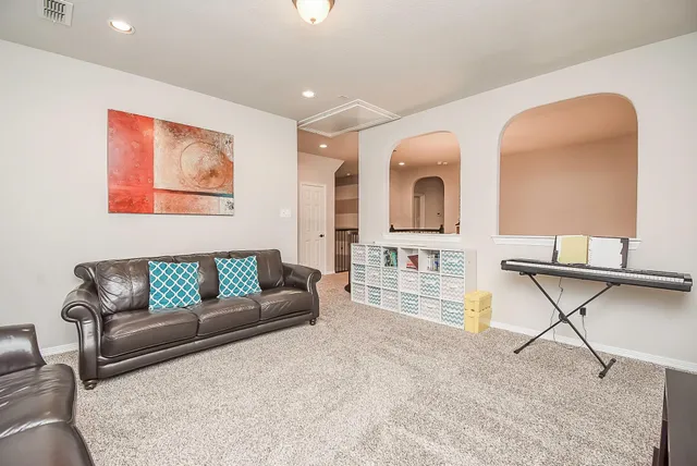 a living room with furniture and a wooden floor