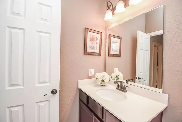 a bathroom with a sink vanity and a mirror