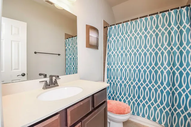 a bathroom with a sink toilet and shower