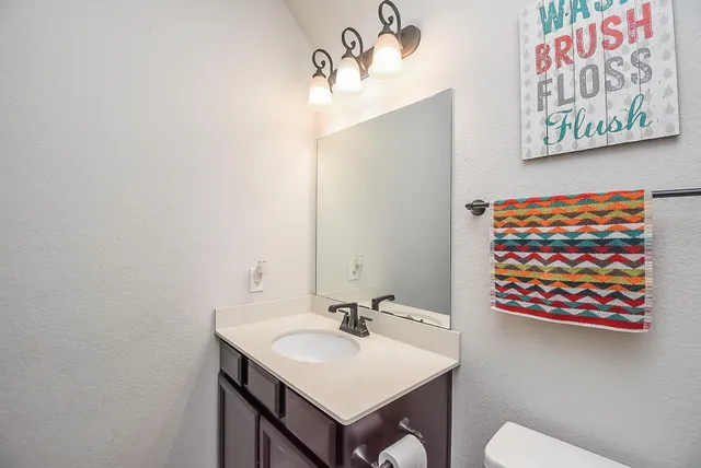 a bathroom with a sink a mirror and a toilet
