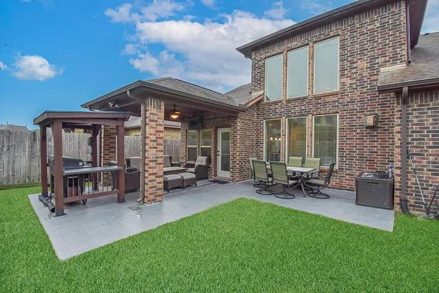 a view of a house with a yard and sitting area