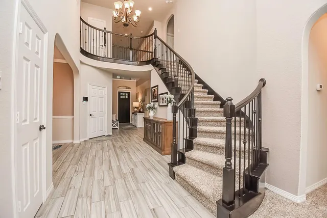a view of entryway and hall with wooden floor