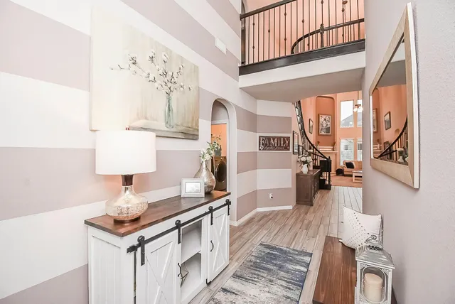 a hallway with a large mirror and a wooden floor