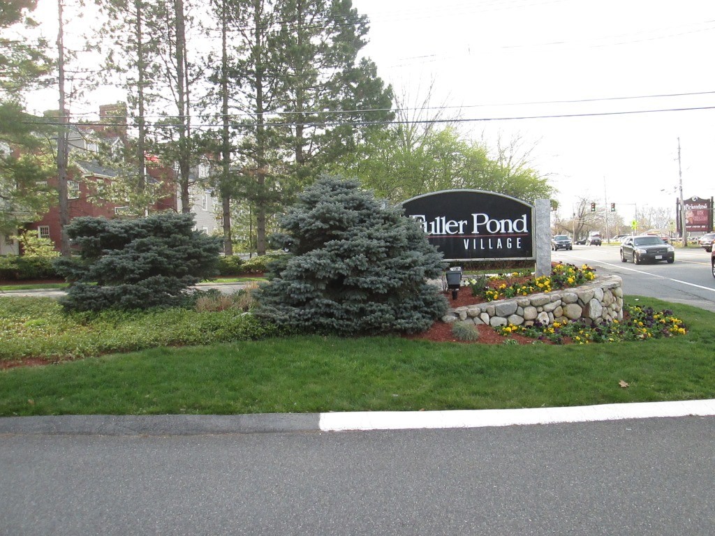 a view of a street sign next to a yard