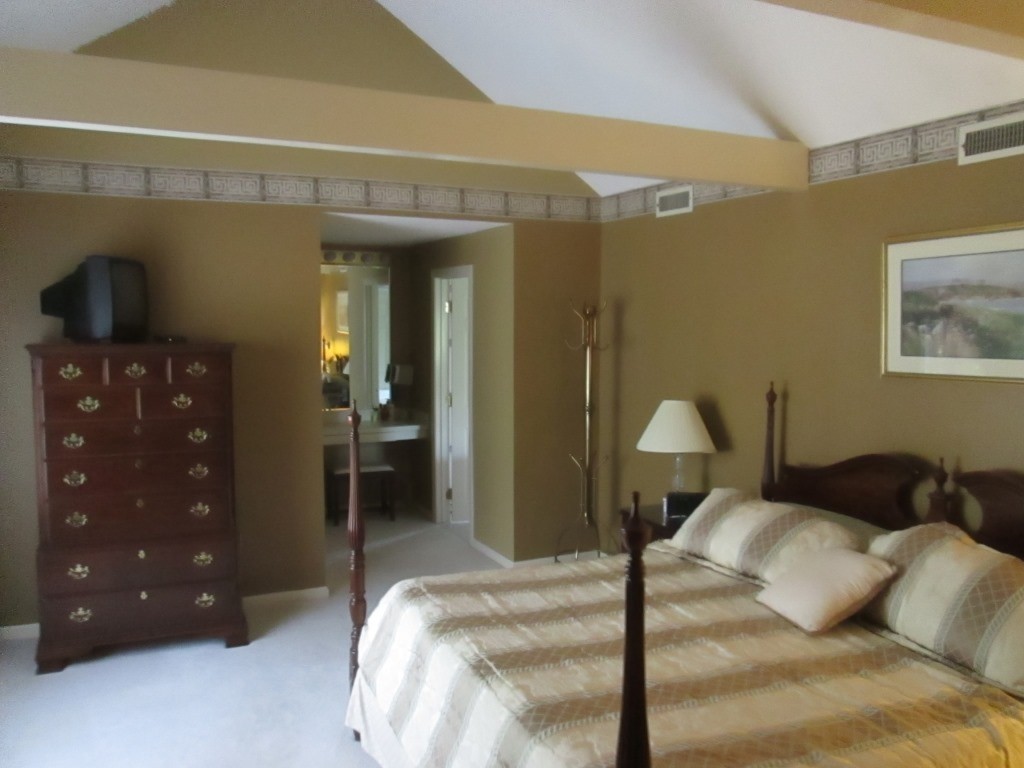 6 Holly Gate Circle, Unit 6 Middleton, MA 01949 - Photo 12 of 23 a bedroom with a bed and a lamp on dresser