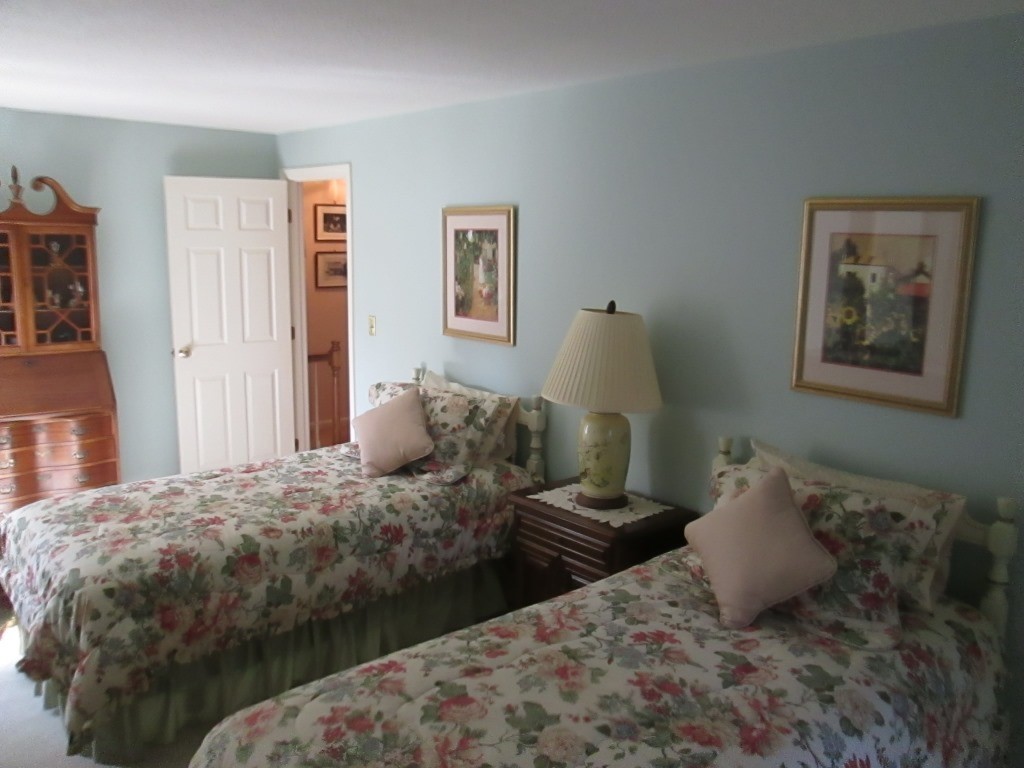 6 Holly Gate Circle, Unit 6 Middleton, MA 01949 - Photo 16 of 23 a bedroom with a bed and painting on the wall