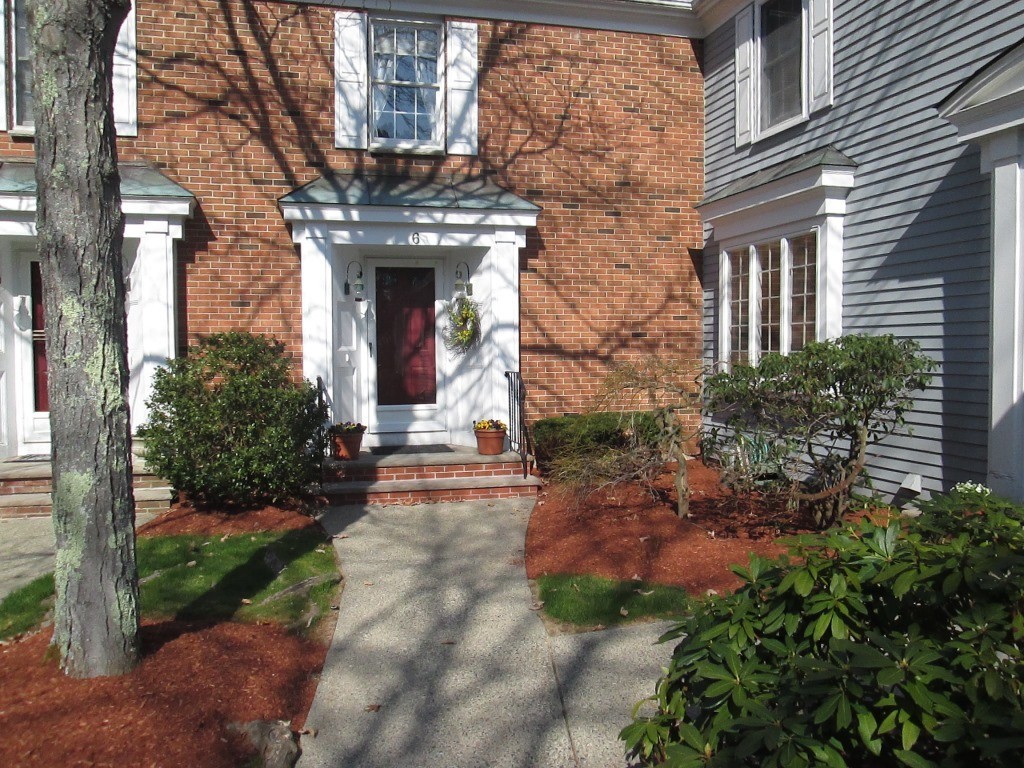 6 Holly Gate Circle, Unit 6 Middleton, MA 01949 - Photo 2 of 23 a view of a house with brick walls and a yard with plants