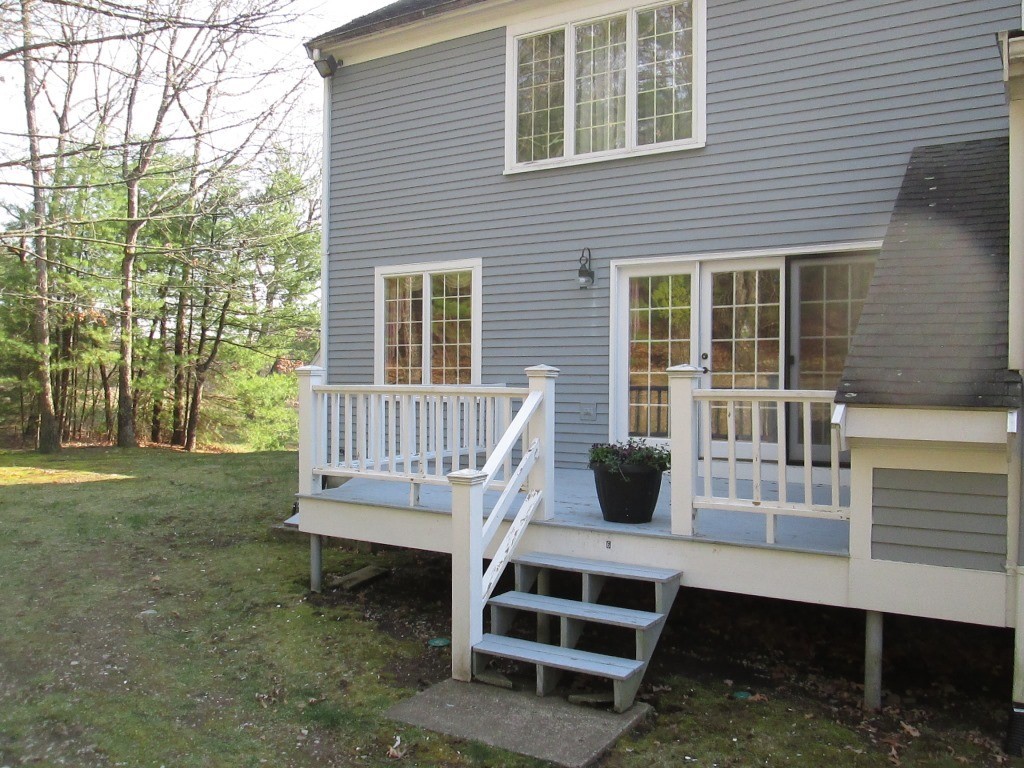 6 Holly Gate Circle, Unit 6 Middleton, MA 01949 - Photo 21 of 23 a view of a deck with a table and chair