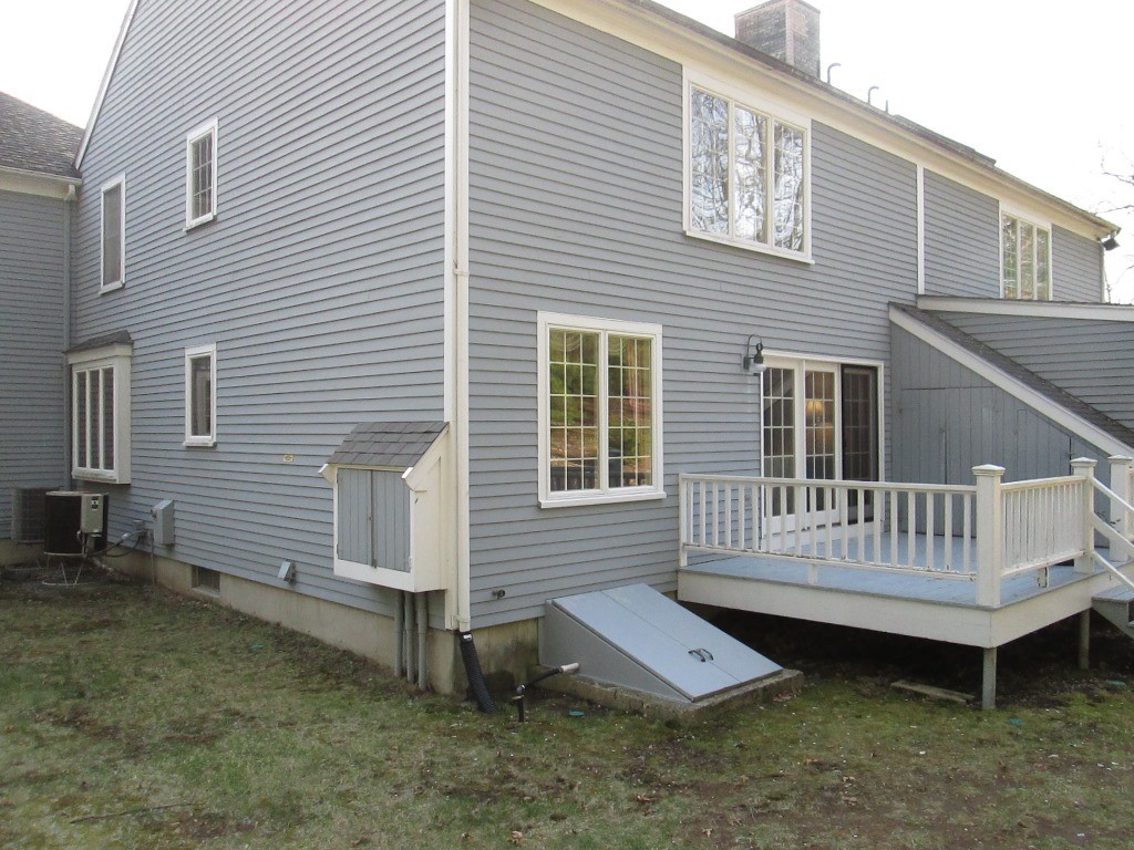 6 Holly Gate Circle, Unit 6 Middleton, MA 01949 - Photo 22 of 23 a view of a house with a yard and deck