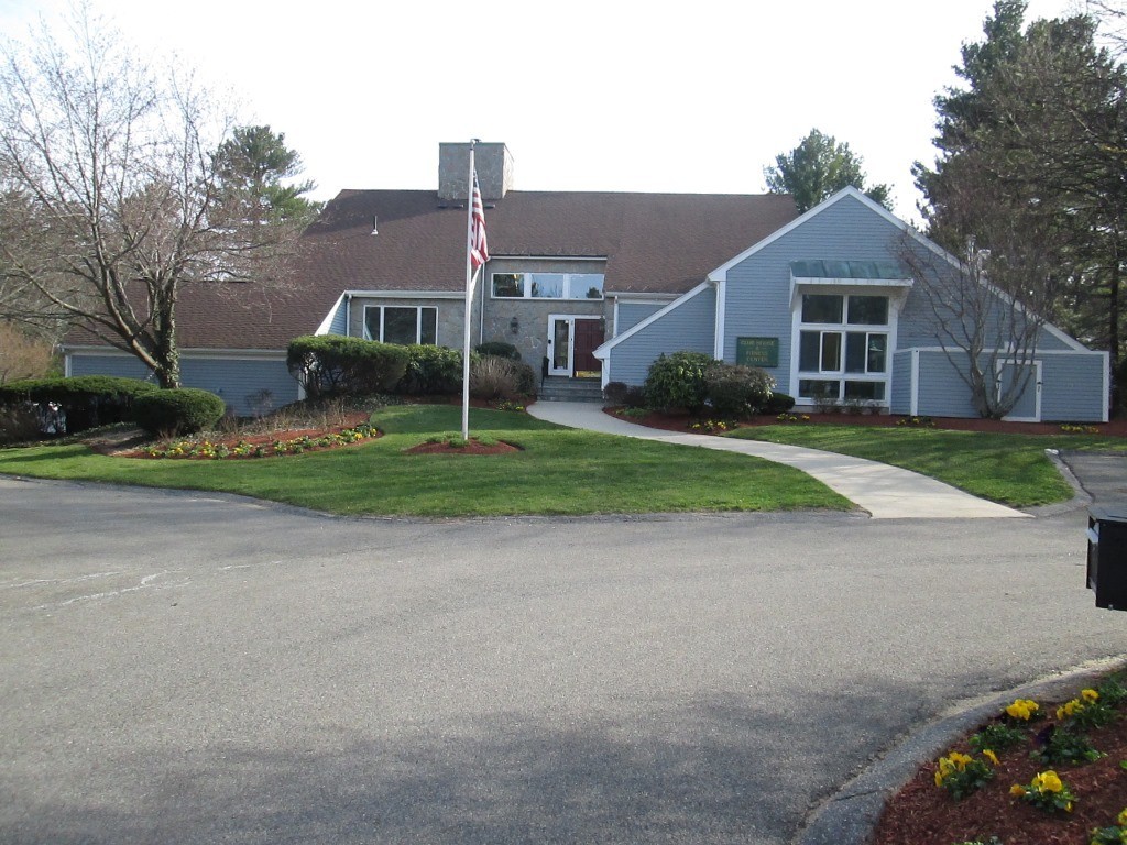 6 Holly Gate Circle, Unit 6 Middleton, MA 01949 - Photo 23 of 23 a front view of a house with a yard and garage