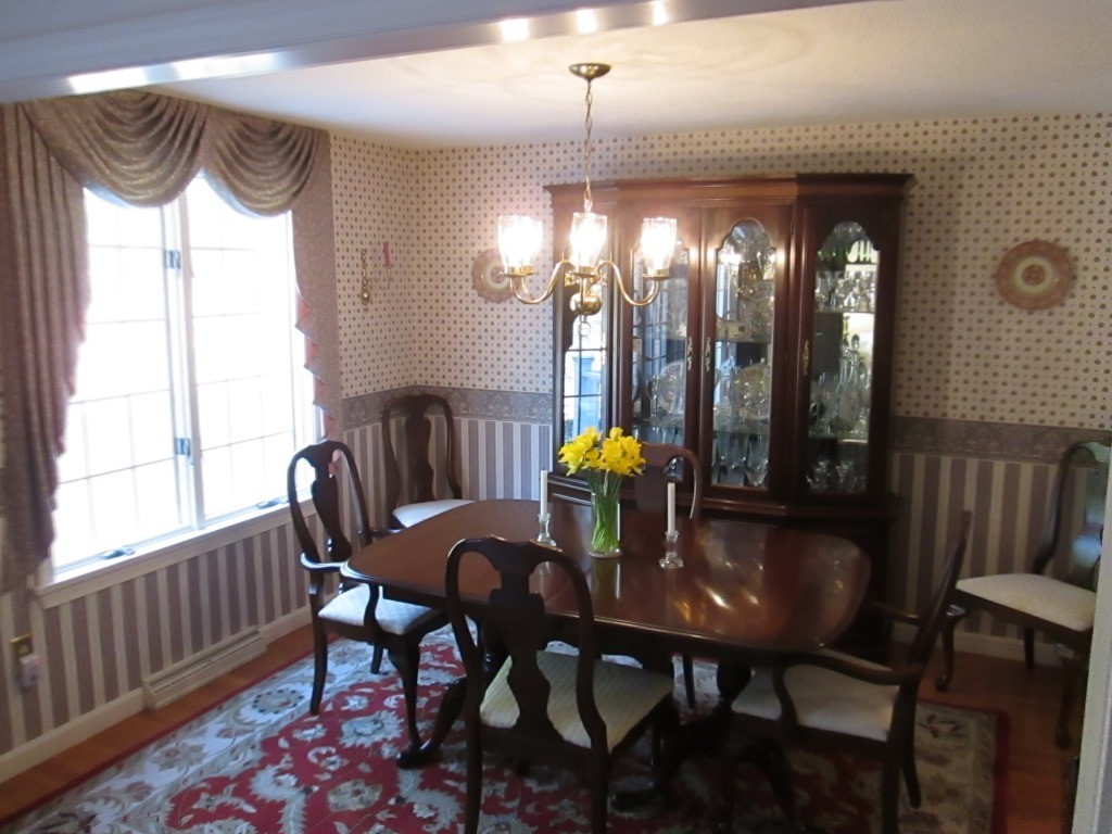 6 Holly Gate Circle, Unit 6 Middleton, MA 01949 - Photo 7 of 23 a view of a dining room with furniture and chandelier