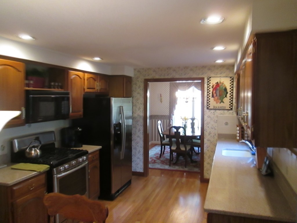 6 Holly Gate Circle, Unit 6 Middleton, MA 01949 - Photo 8 of 23 a kitchen with stainless steel appliances granite countertop a refrigerator stove and sink