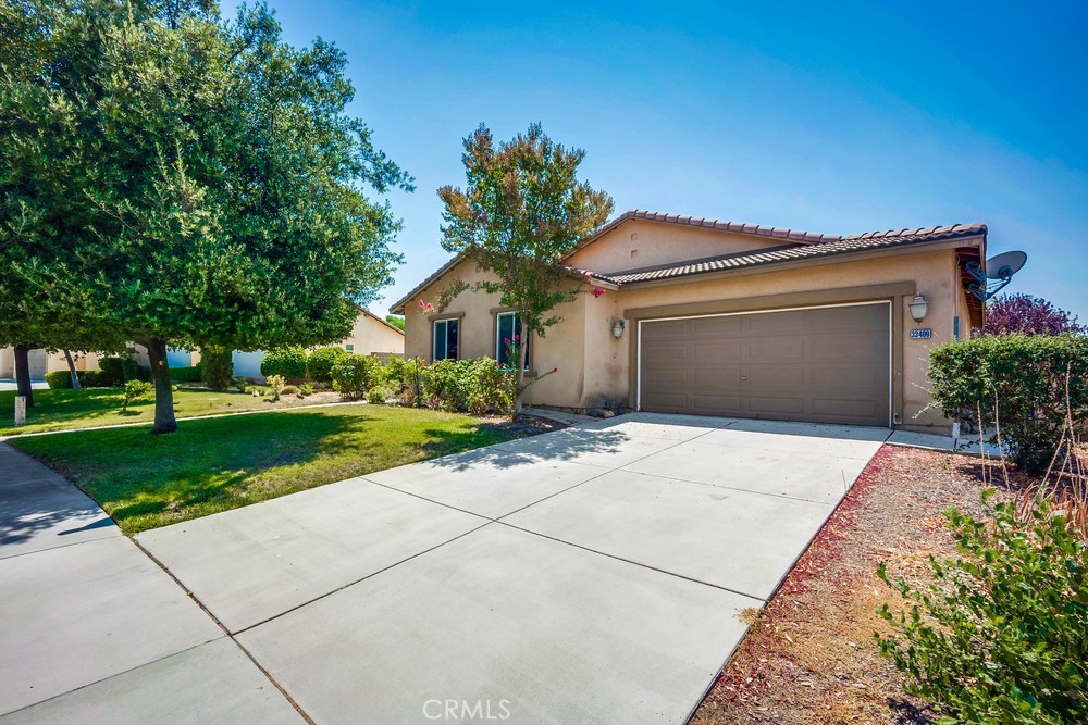 a front view of a house with a yard and a garage