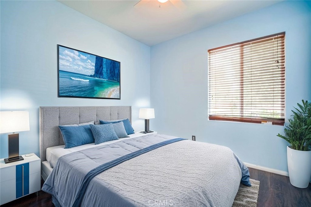 33409 Mesolite Way Menifee, CA 92584 - Photo 11 of 18 a bedroom with a bed and a potted plant