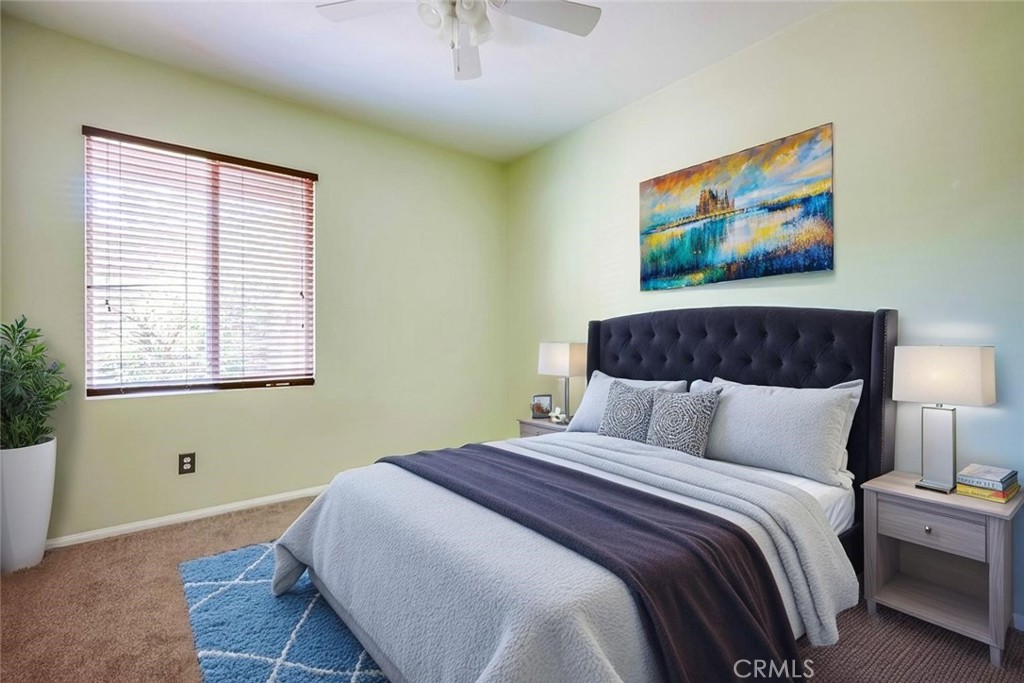33409 Mesolite Way Menifee, CA 92584 - Photo 12 of 18 a bedroom with a bed and a painting on the wall