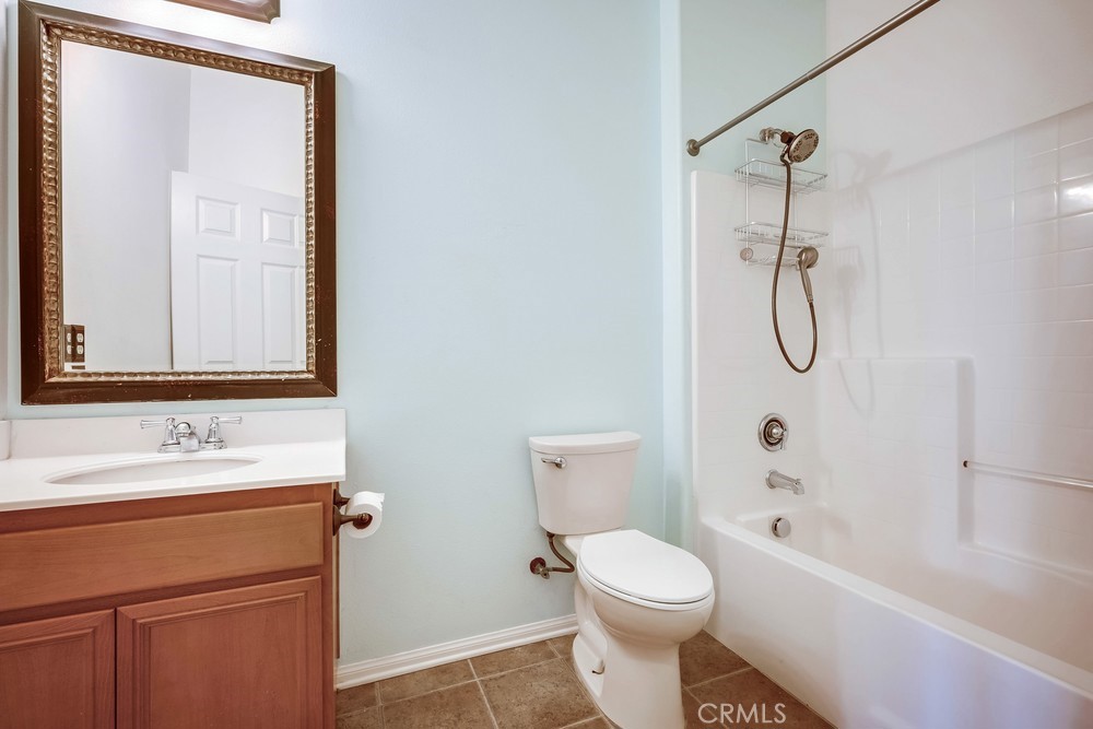 33409 Mesolite Way Menifee, CA 92584 - Photo 13 of 18 a bathroom with a granite countertop toilet sink and a mirror