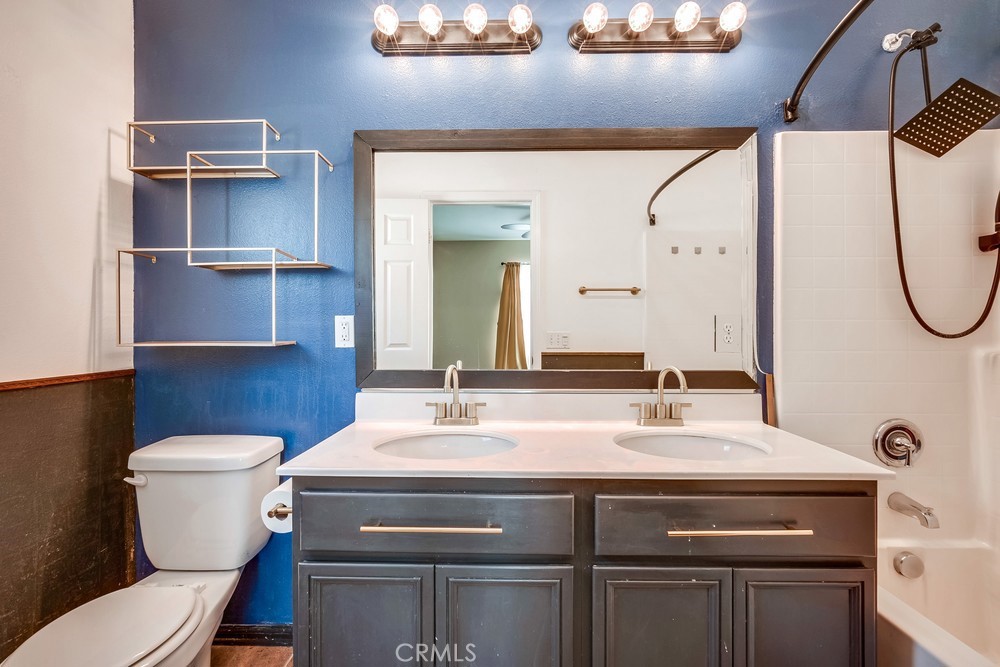 33409 Mesolite Way Menifee, CA 92584 - Photo 8 of 18 a bathroom with a sink a toilet and a mirror