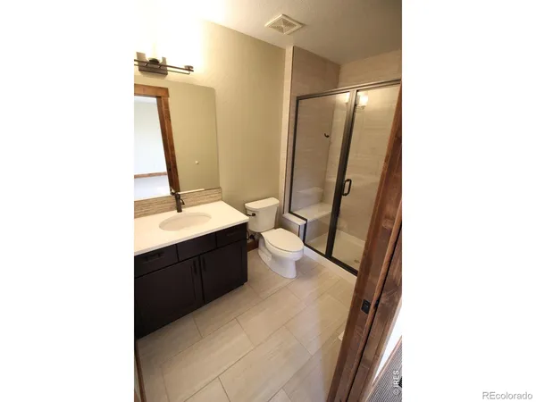 a bathroom with a double vanity sink and mirror