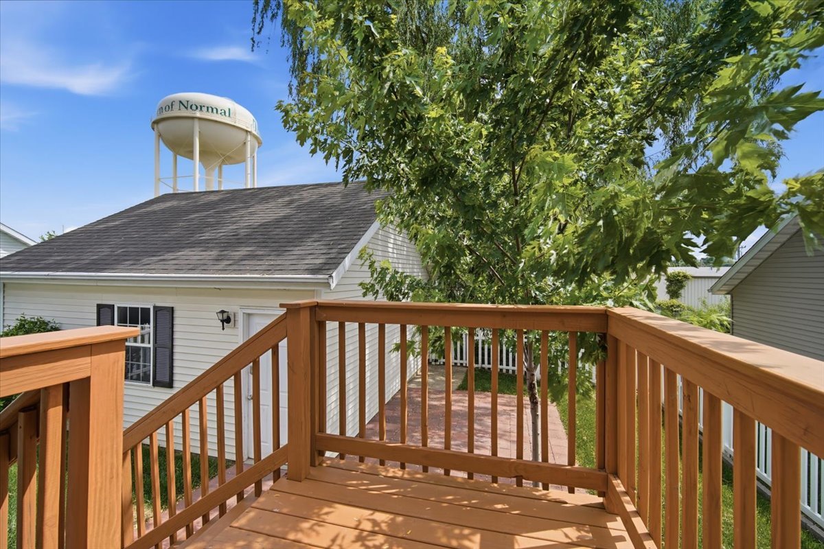 915 Teegan Street Normal, IL 61761 - Photo 13 of 33 a balcony with wooden floor and fence