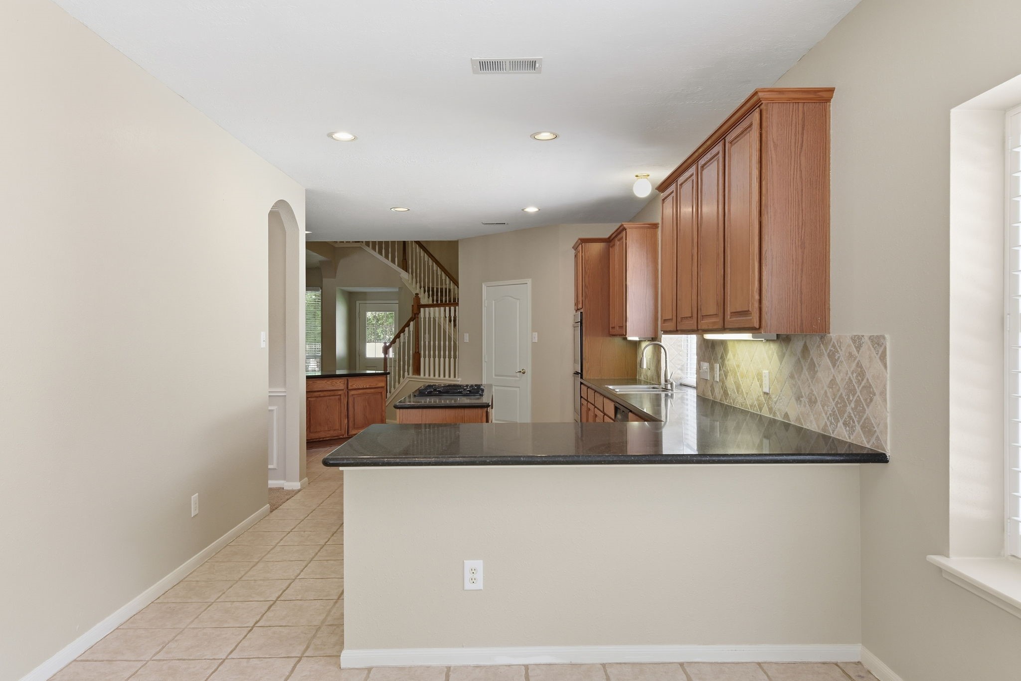3414 Hackberry Court Spring, TX 77388 - Photo 16 of 50 A look at the kitchen from the breakfast room. Another "bar" area here for your breakfast dining Bring on the cute stools!