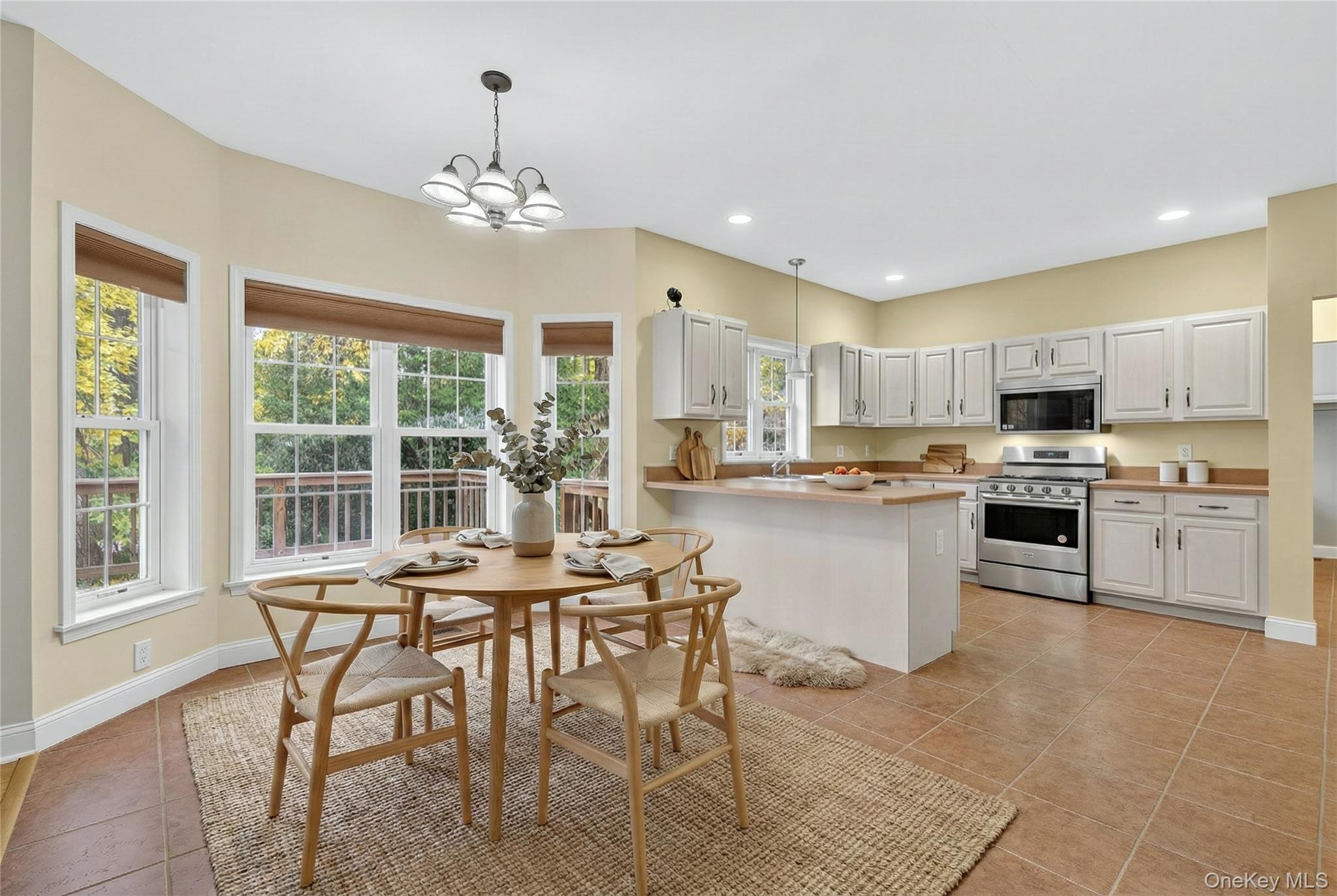 9 Exeter Circle Beacon, NY 12508 - Photo 11 of 41 a kitchen with stainless steel appliances granite countertop a stove top oven a sink dishwasher and a dining table with wooden floor
