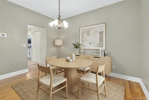 a view of a room that has a table and a chandelier