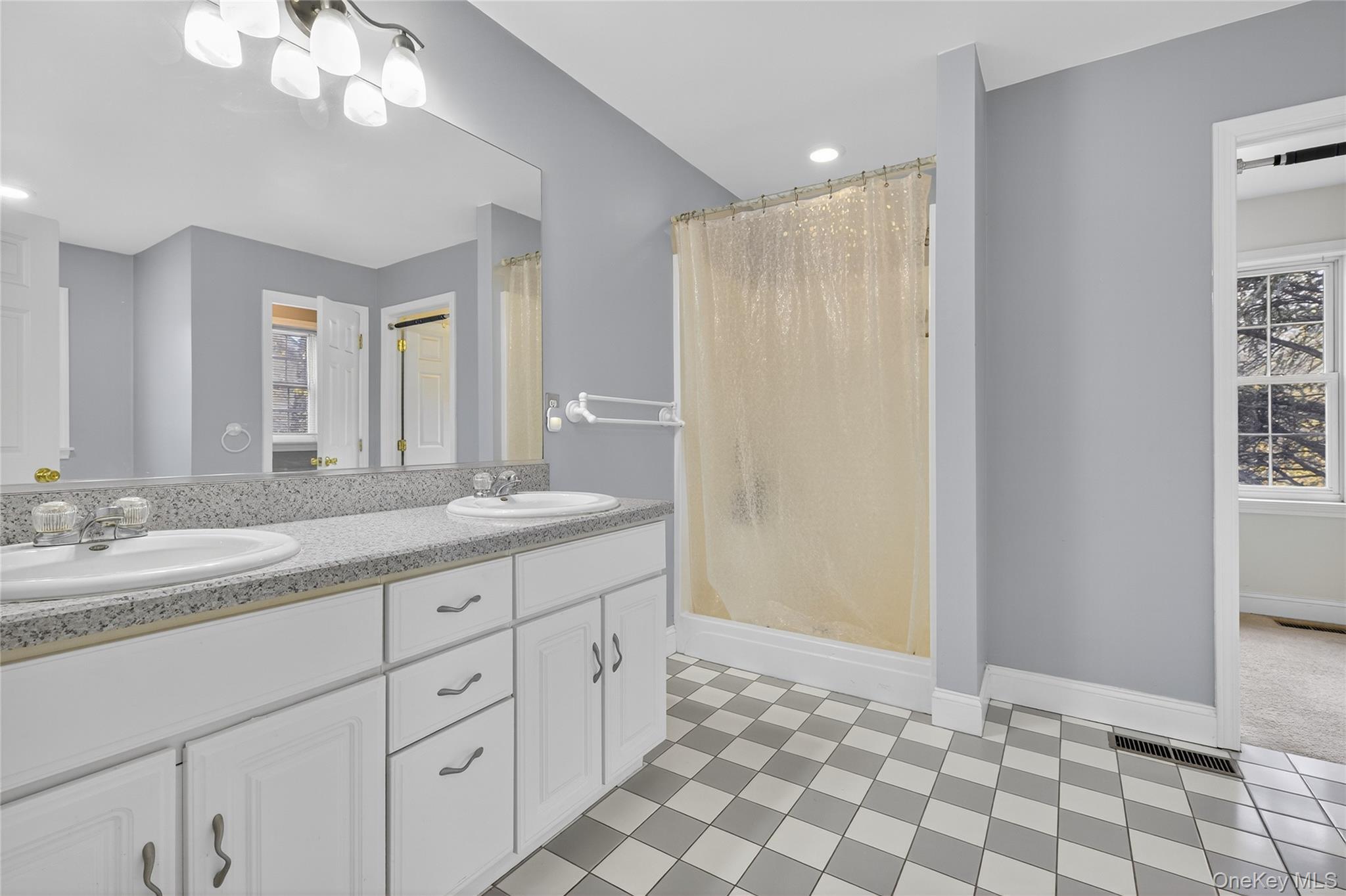 9 Exeter Circle Beacon, NY 12508 - Photo 22 of 41 a spacious bathroom with a granite countertop sink a mirror and a shower