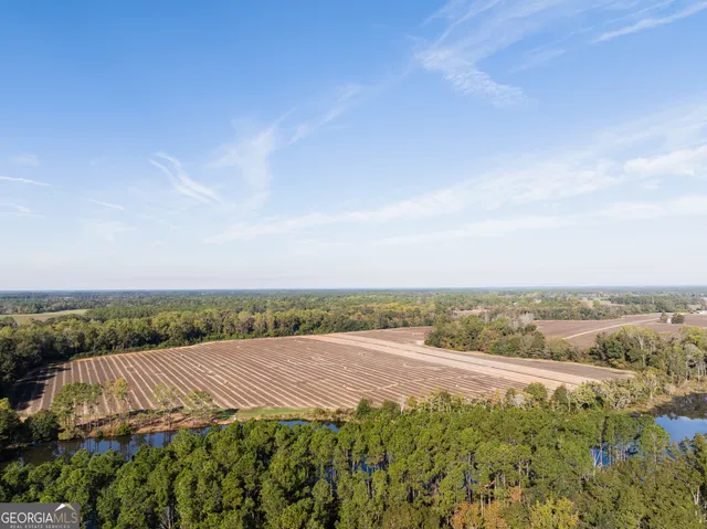 a view of a lake with beach and city view