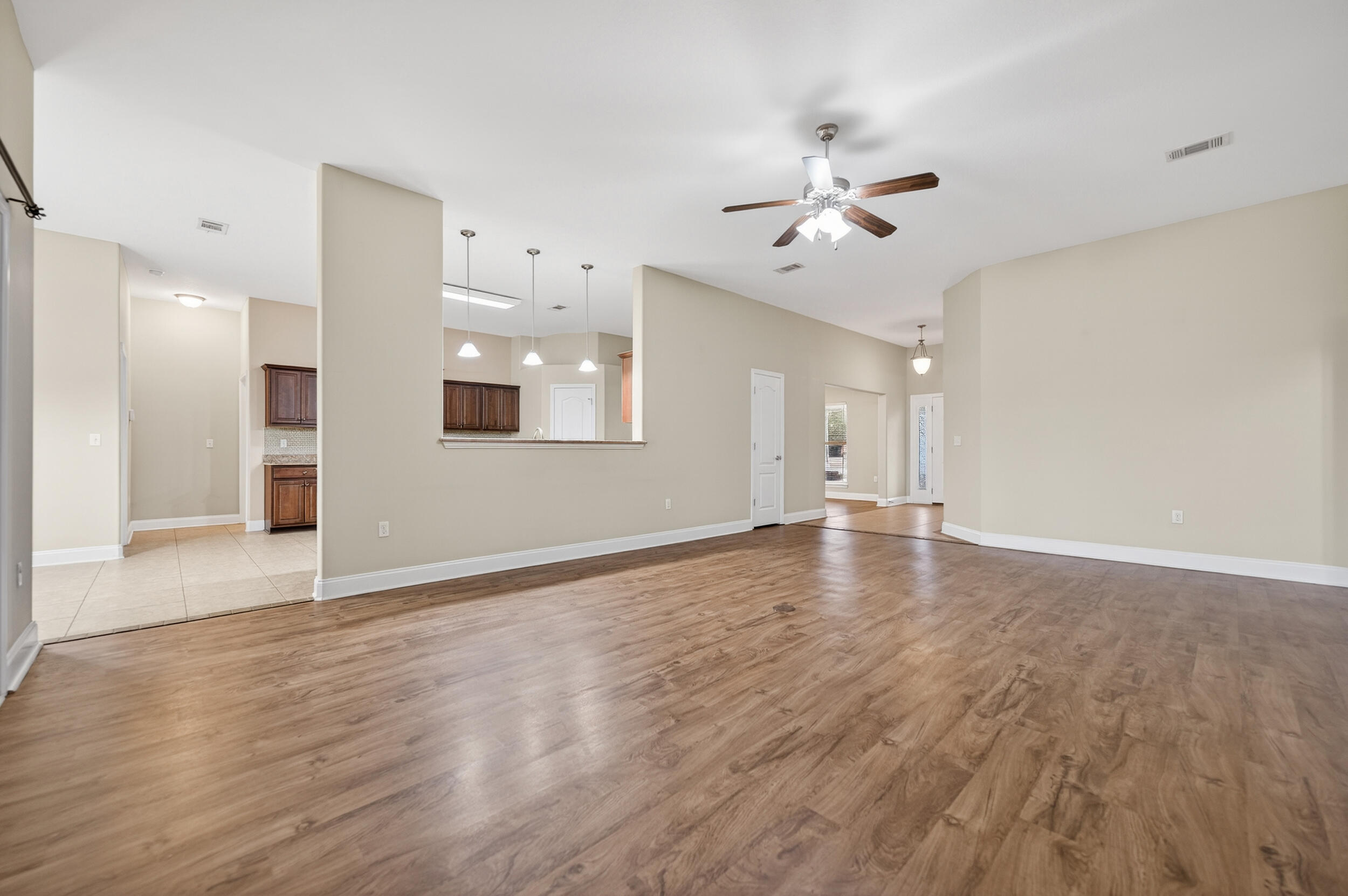 6210 Lapis Lane Crestview, FL 32539 - Photo 11 of 72 an empty room with wooden floor and windows