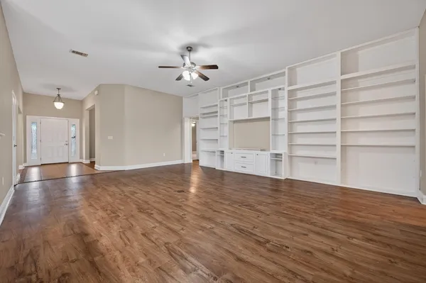 a kitchen with stainless steel appliances granite countertop a stove top oven a sink dishwasher and a refrigerator with wooden cabinets