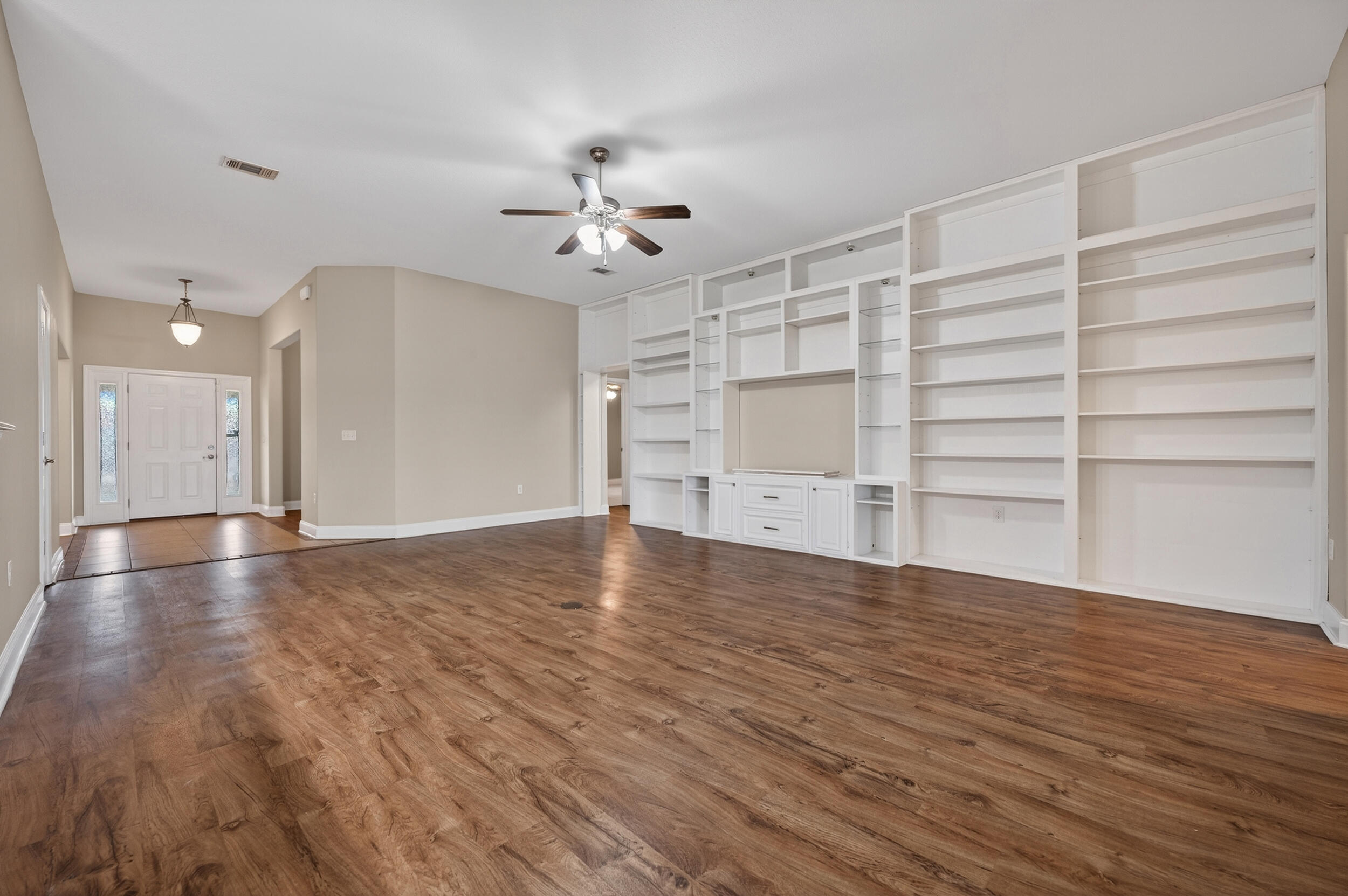 6210 Lapis Lane Crestview, FL 32539 - Photo 12 of 72 a view of an empty room with a window and wooden floor