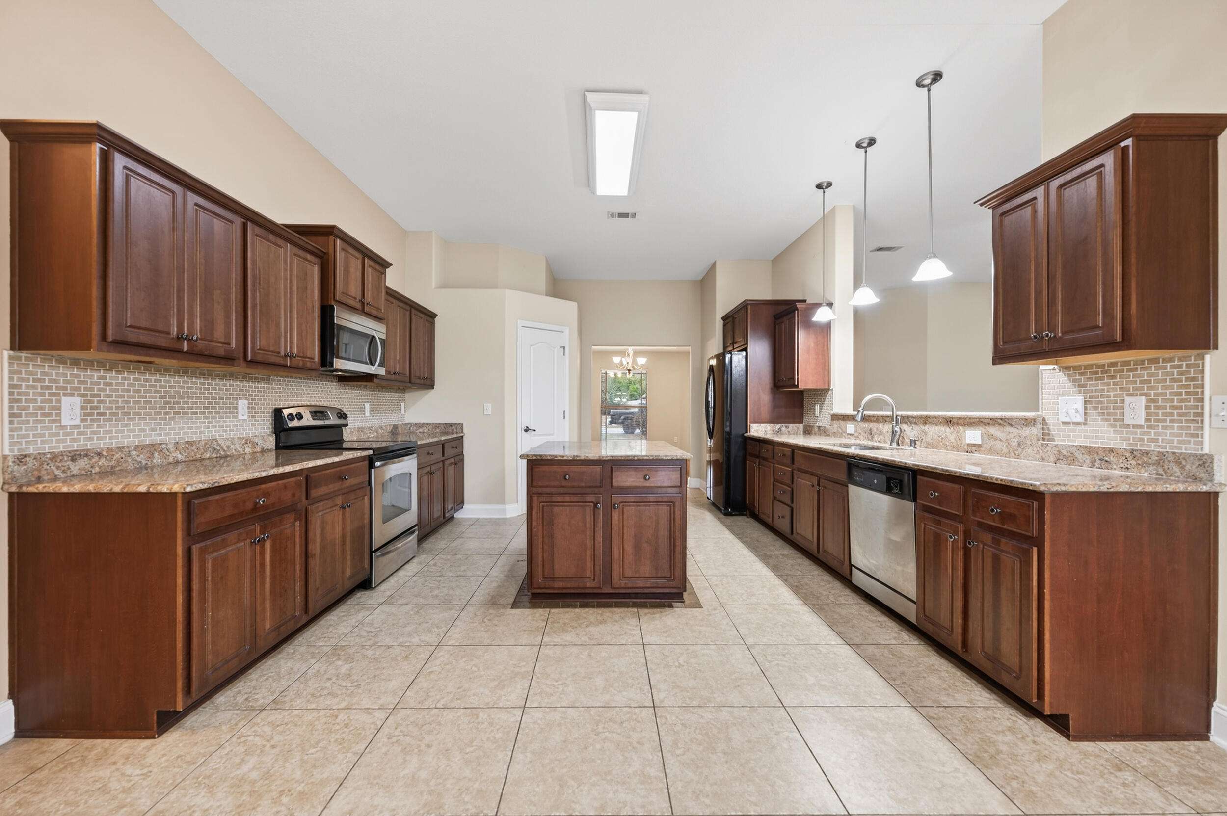 6210 Lapis Lane Crestview, FL 32539 - Photo 14 of 72 a large kitchen with stainless steel appliances and cabinets