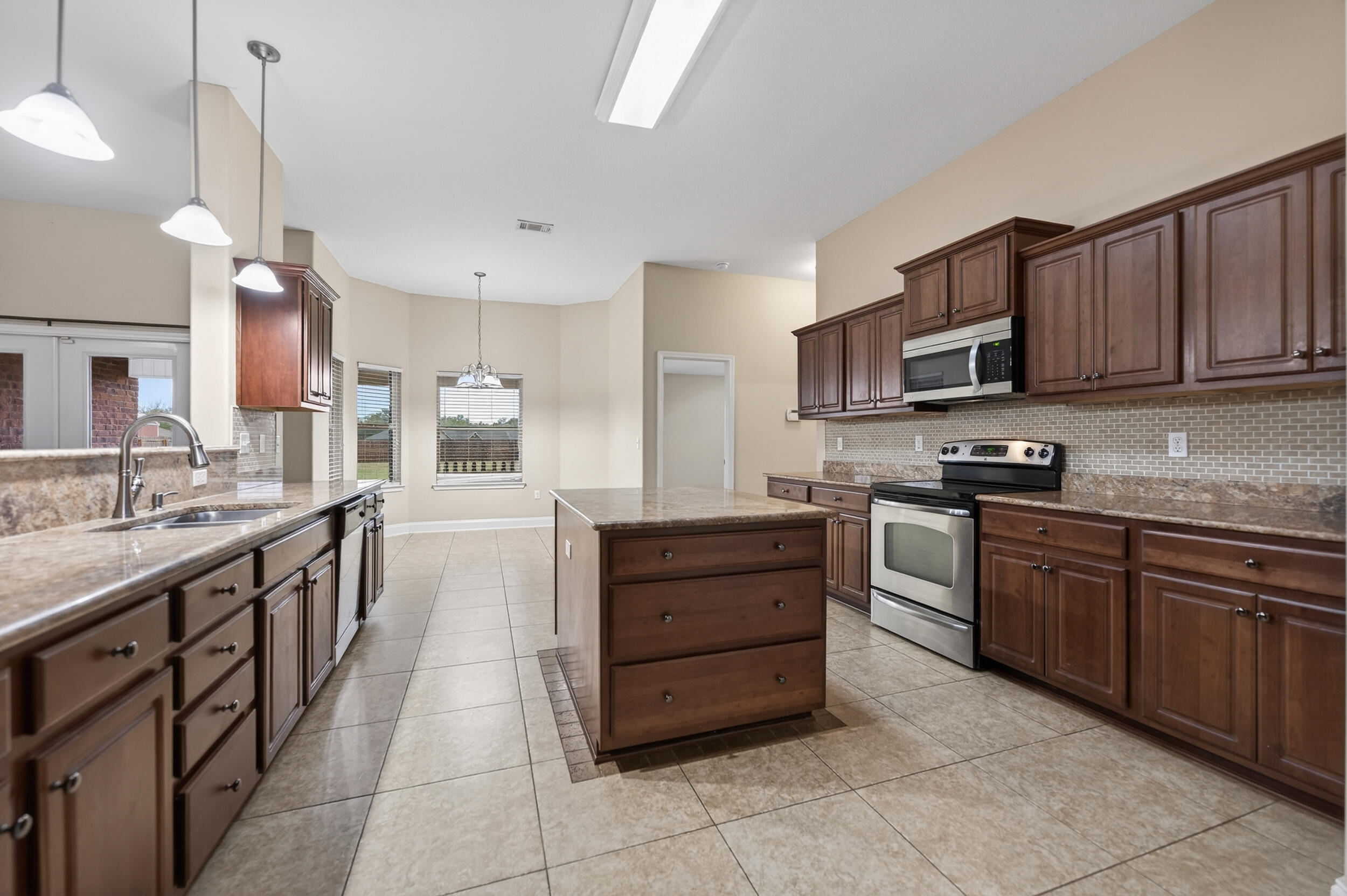 6210 Lapis Lane Crestview, FL 32539 - Photo 17 of 72 a kitchen with stainless steel appliances granite countertop a stove and a sink