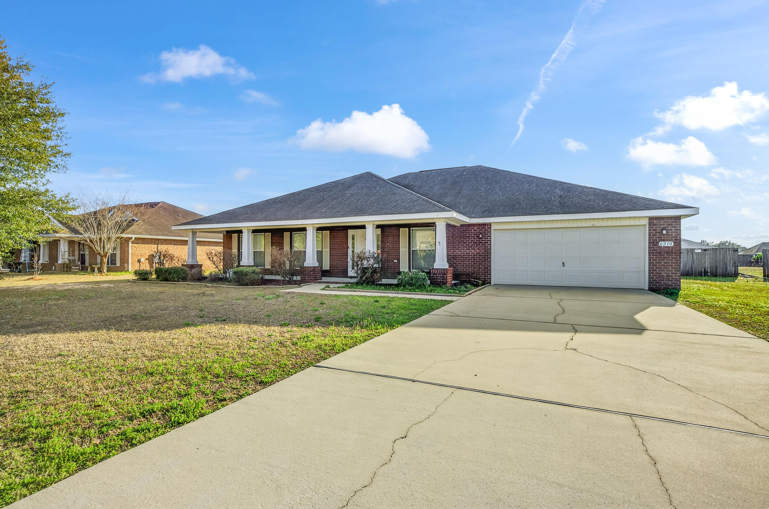 6210 Lapis Lane Crestview, FL 32539 - Photo 2 of 72 a front view of a house with a garden and yard